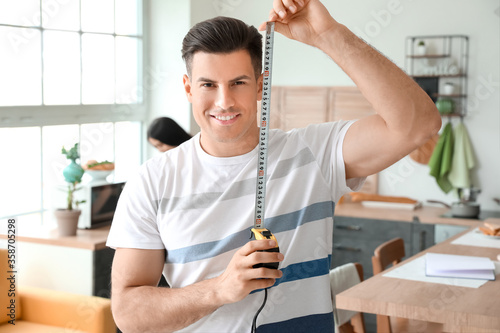 Young man with measuring ta...