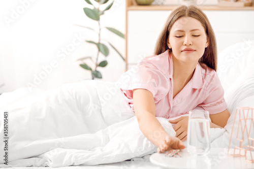 Young woman taking sleeping...