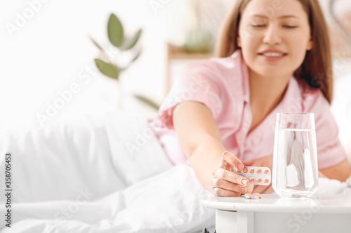 Young woman taking sleeping...