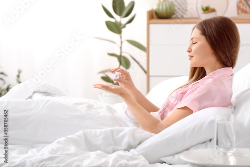 Young woman taking sleeping...