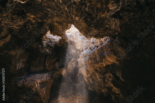 light falls through the cave opening from above
