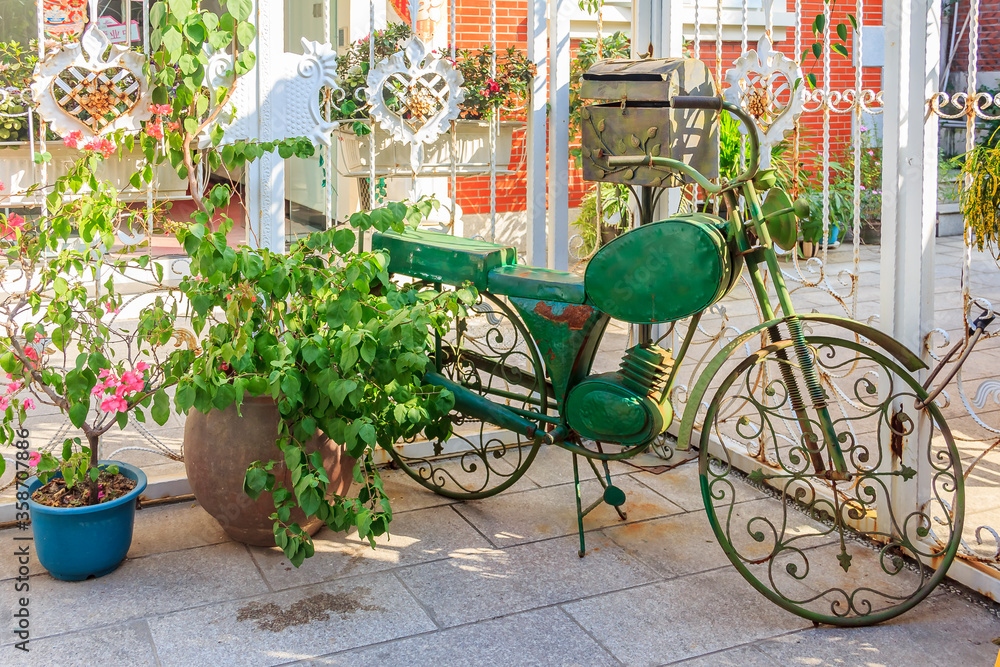 Ornate bicycle and potted plant on the streets of Gulangyu Island in China