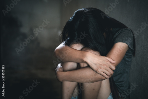 Canvas-taulu Young depressed woman, domestic and rape violence,beaten and raped sitting in the corner,  Copy space