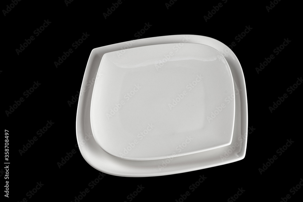 Empty round dish for food. Dinner background. White plate isolated on black. Restaurant kitchen minimalistic concept. Empty round dish for food. Dinner background. White plate isolated on black. Restaurant kitchen minimalistic concept.