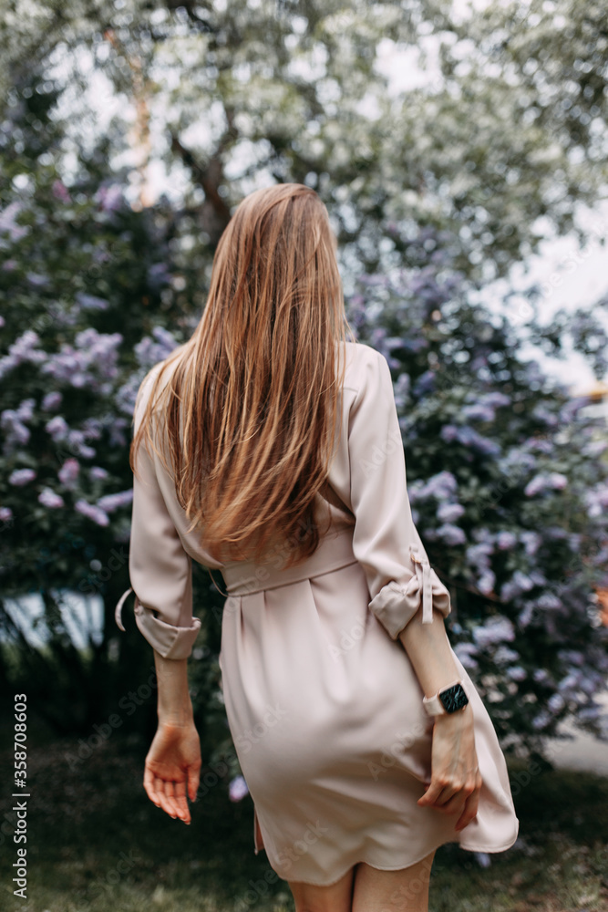 Luxury woman with a lilac flowers. Smile girl in park outdoor. Luxury woman with a lilac flowers. Smile girl in park outdoor.