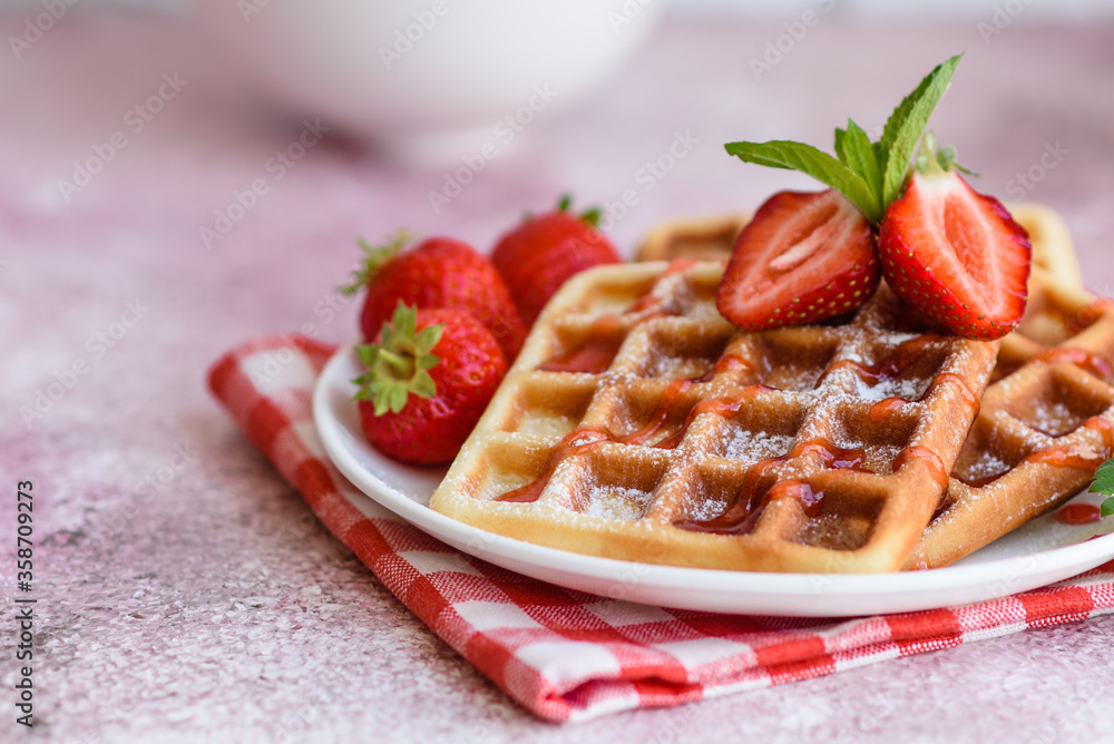 Delicious fresh baked belgian waffles with berries and fruit Delicious fresh baked belgian waffles with berries and fruit