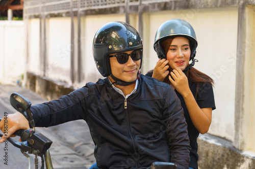 Couple are traveling by motorcycle.