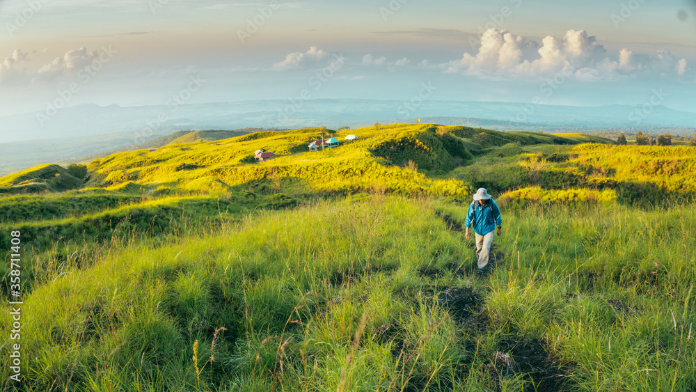 Hiker trekking in the mountains in Mount Tambora via Doro Ncanga Track, Sumbawa Island, Indonesia. Sport and active life 