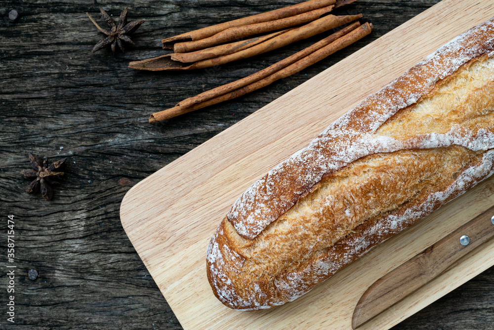 A closeup top view of freshly baked traditional Italian Ciabatta breads prepared and cut in to slices on a wooden table read to be served A closeup top view of freshly baked traditional Italian Ciabatta breads prepared and cut in to slices on a wooden table read to be served
