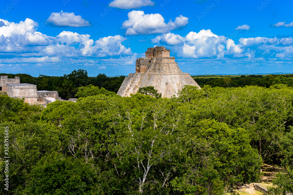 Pyramid of the Magician in the jungle,  a Mesoamerican step pyramid, Uxmal, an ancient Maya city of the classical period. UNESCO World Heritage site