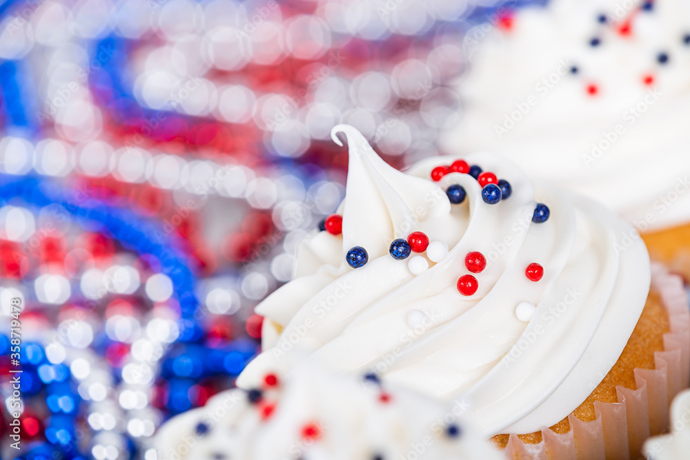 Patriotic 4th of July or Memorial Day celebration cupcakes with festive red, white, and blue theme decorations. Closeup. 