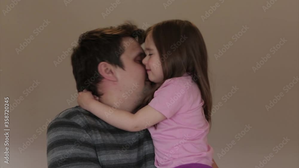 father's day. dad holds children in his arms and hugs them. girls kiss a man. I love you, dad! father's day. dad holds children in his arms and hugs them. girls kiss a man. I love you, dad!