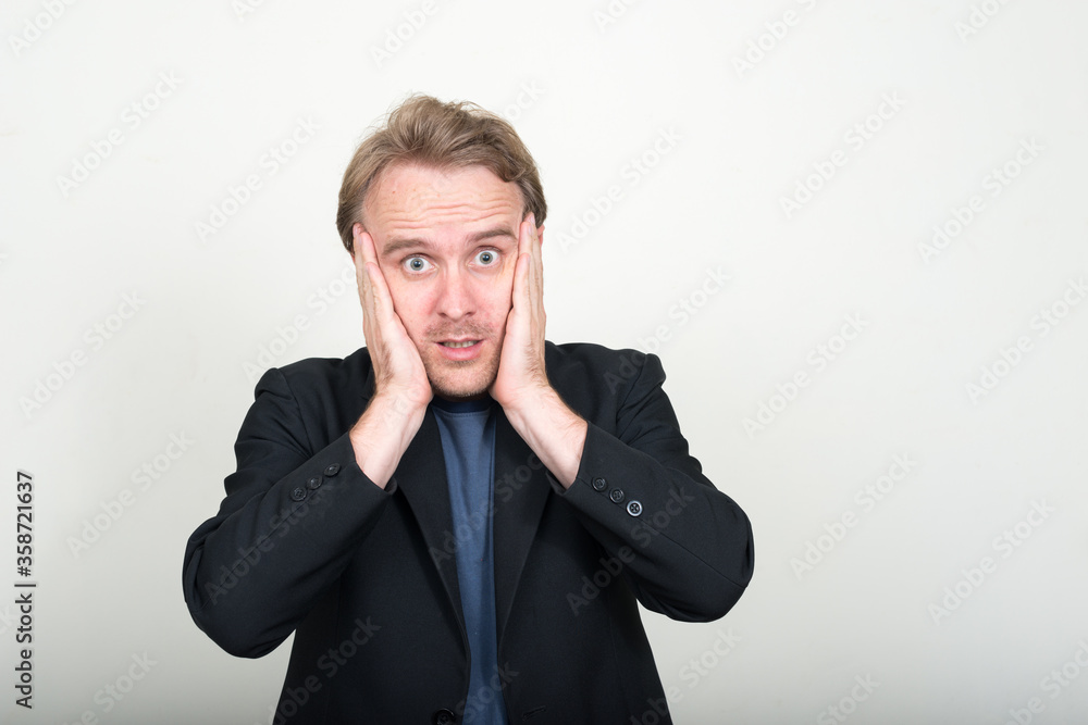 Portrait of stressed businessman with blond hair looking shocked Portrait of stressed businessman with blond hair looking shocked