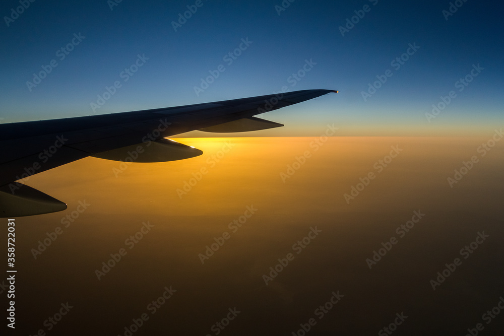 Blue sky with white clouds from the plane view. Cumulus clouds. Sunset Blue sky with white clouds from the plane view. Cumulus clouds. Sunset