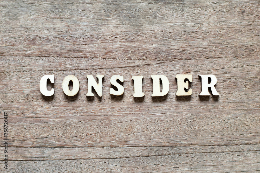 Alphabet letter block in word consider on wood background Alphabet letter block in word consider on wood background