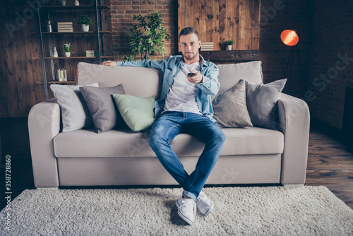 Bild auf Leinwand Photo of domestic funny handsome guy relaxing sit comfy couch staying home good