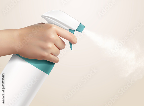 Hand holding a disinfectant spray