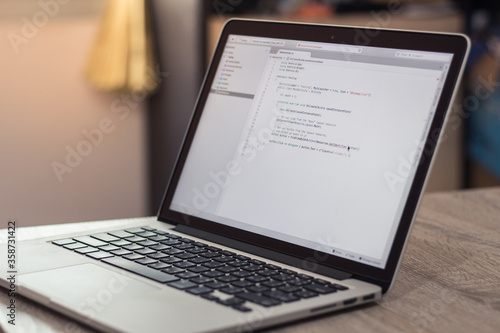 Concept working at home, Man typing programming in laptop Selective focus on the screen.
