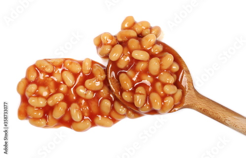 Cooked white beans in red tomato sauce with wooden spoon isolated, top view
