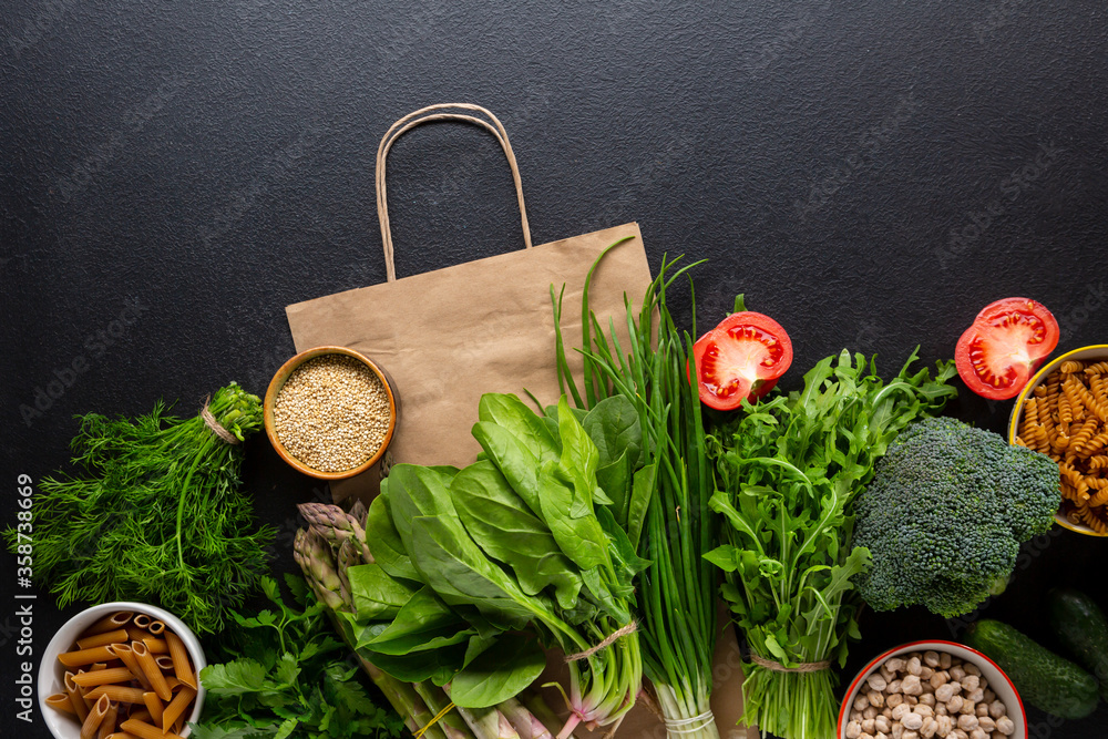 Organic food and shopping bag, top view dark background