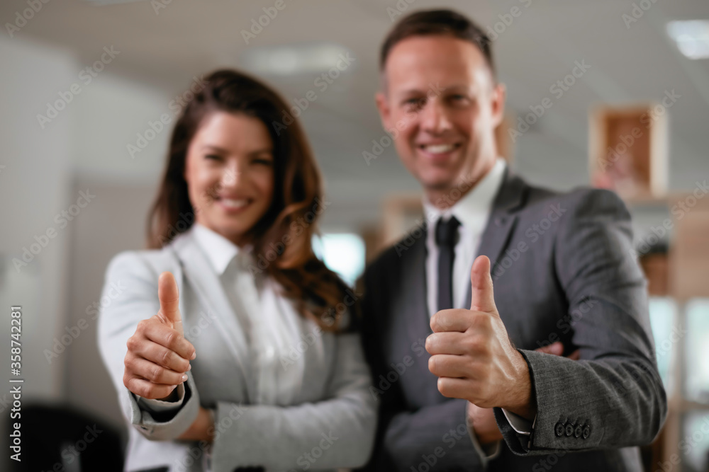Businesswoman and businessman showing thumbs up. Businesswoman and businessman showing thumbs up.