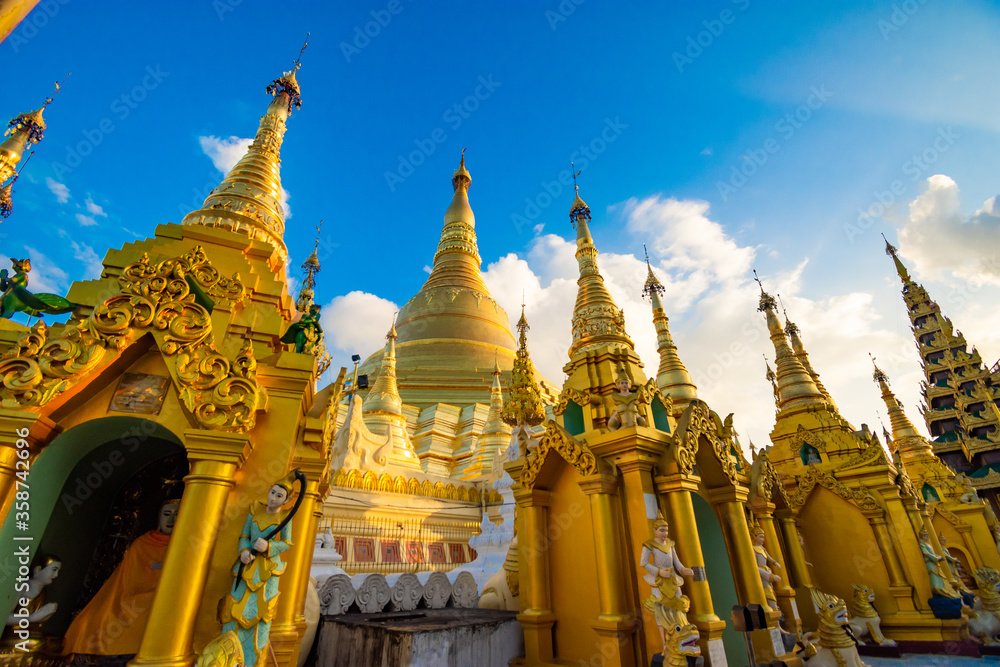 Fototapeta premium YANGON,MYANMAR-MAY 15.2020: Buddhist Pilgrims in the Shwedagon Pagoda at night. It is the most sacred Buddhist pagoda for the Burmese.