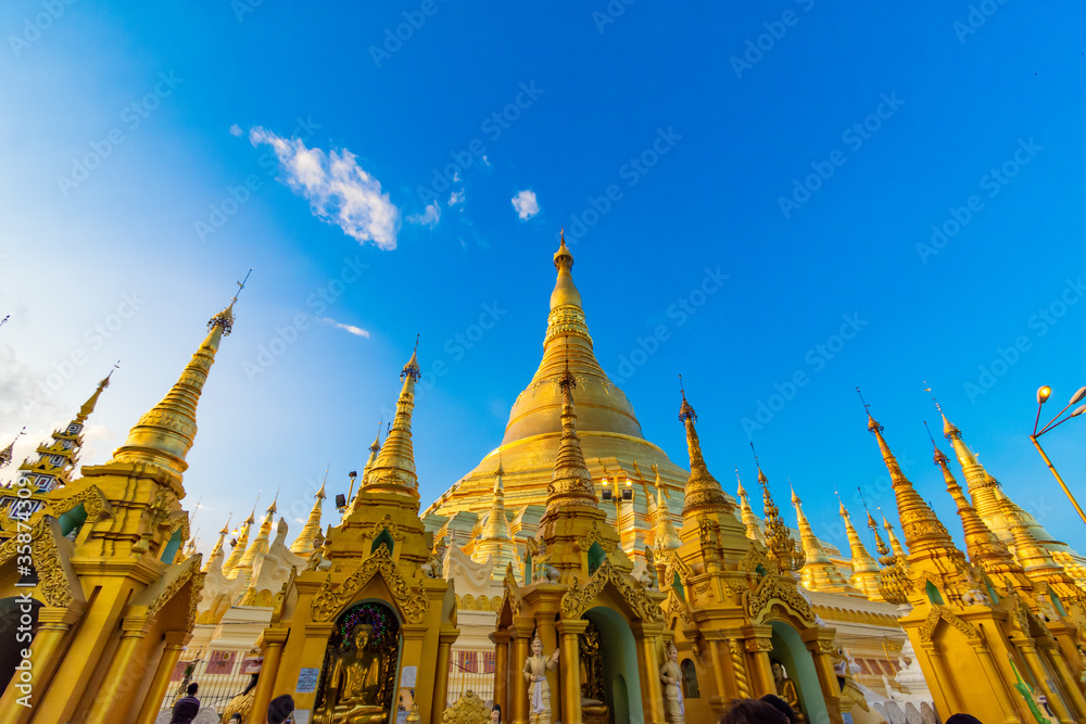 Fototapeta premium YANGON,MYANMAR-MAY 15.2020: Buddhist Pilgrims in the Shwedagon Pagoda at night. It is the most sacred Buddhist pagoda for the Burmese.