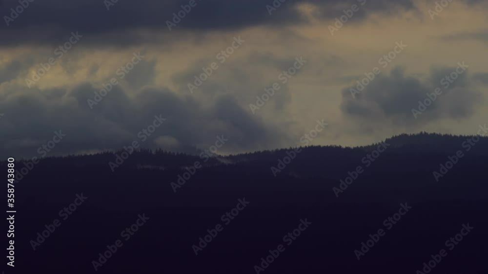 Clouds rolling over the misty mountain forest of North Vancouver during a rainy day - wide Clouds rolling over the misty mountain forest of North Vancouver during a rainy day - wide