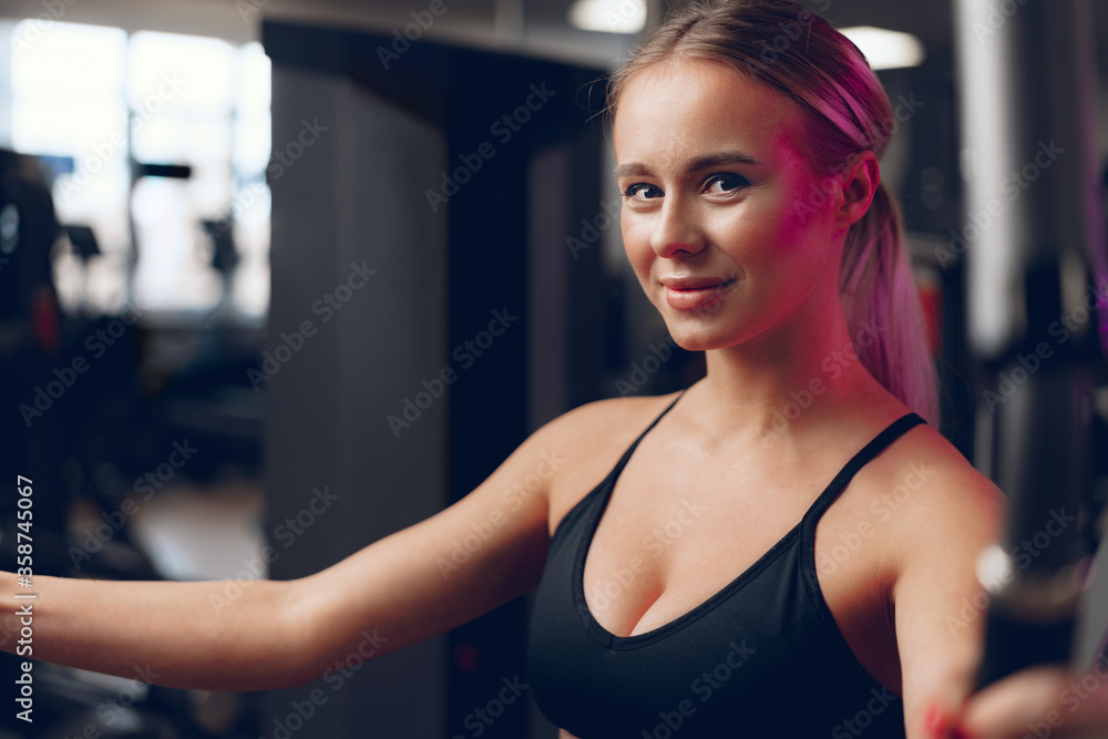 Young caucasian blonde woman training hands in a gym Young caucasian blonde woman training hands in a gym