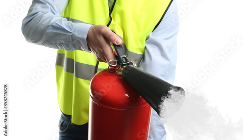 Fotografía Worker using fire extinguisher on white background, closeup