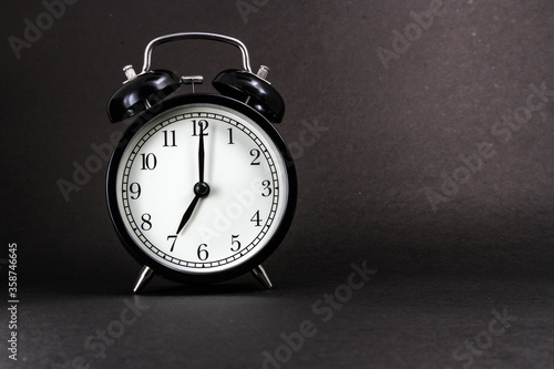 Wallpaper Mural An old alarm clock showing 7 o'clock on a black background Torontodigital.ca