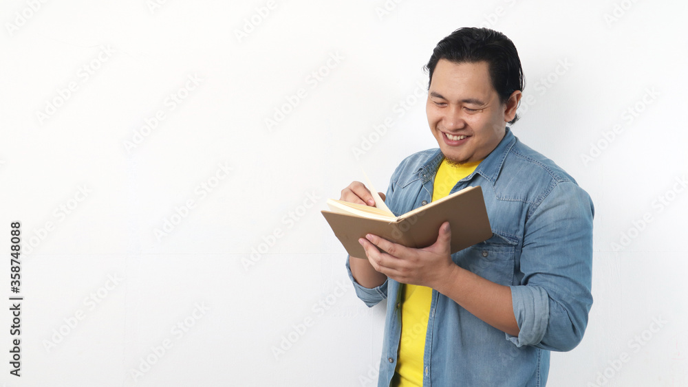 Happy Man Smiling While Reading Book Happy Man Smiling While Reading Book