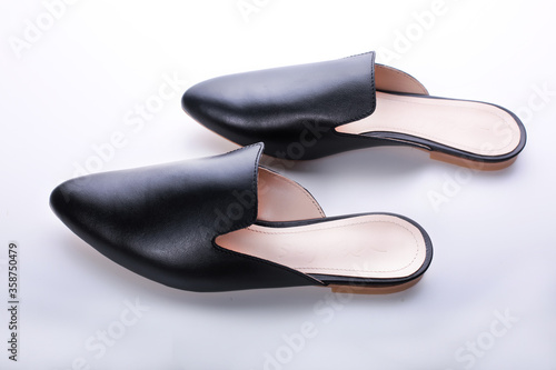 ballet shoes on a white background, black women’s flat shoes, classic, leather mules and loafers, leather substitute