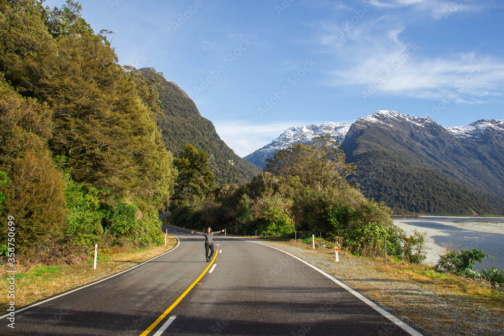 Woman in the road close to Franz Josef Glacier. New Zealand South Island. June ‎12, ‎2018