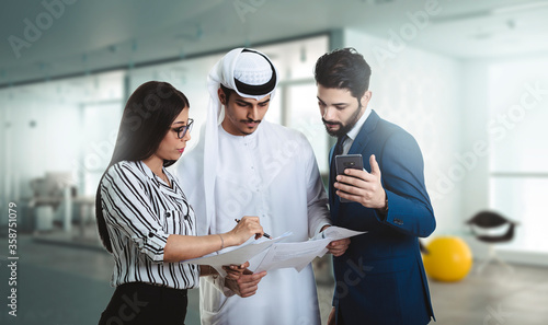 Three business partners discussing paperwork in the office. business meeting.