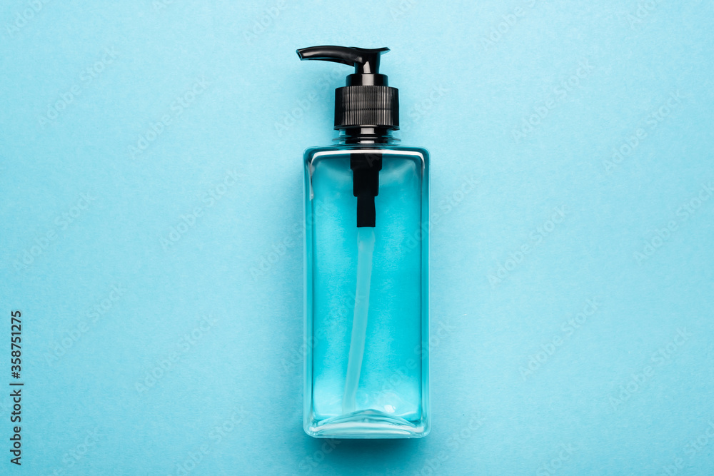 top view of antiseptic liquid in transparent bottle on blue top view of antiseptic liquid in transparent bottle on blue