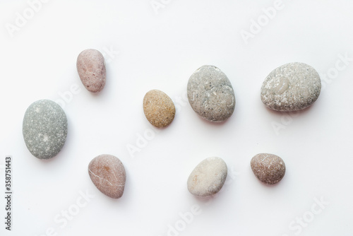 sea stones on white background, smooth stones