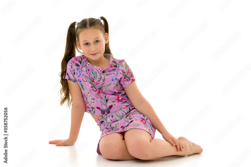 Little girl hugging her knees. sitting on the floor. Little girl hugging her knees. sitting on the floor.