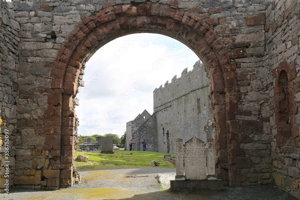 A large archway in a ruined Irish cathedral.