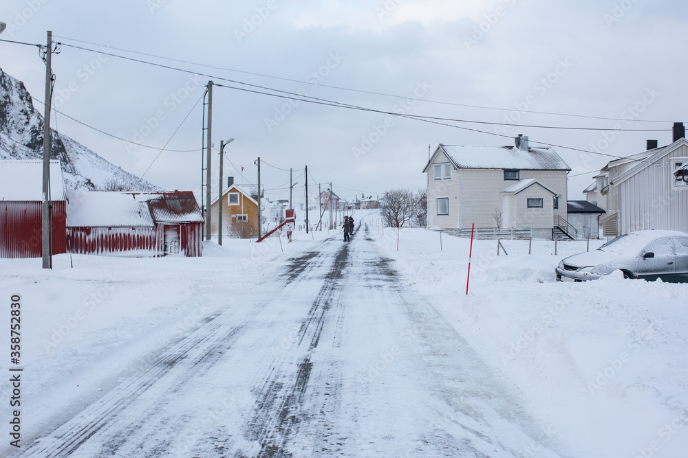 A remote arctic village during a snow storm. 