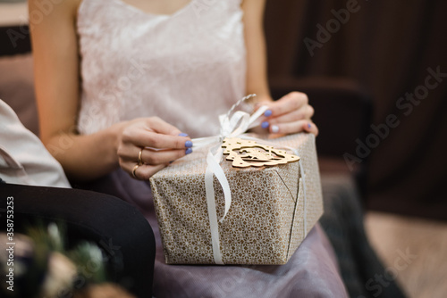 close up of a person holding a gift box