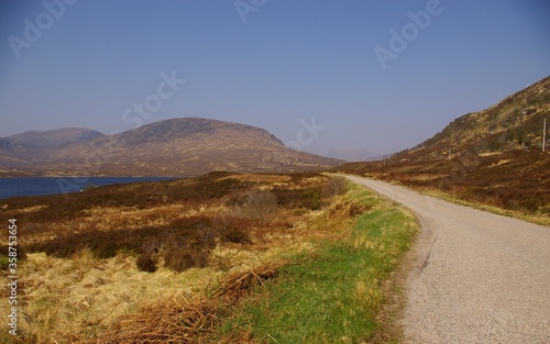 The road along Loch Shin highlights the bleak beauty of Sutherland, Scotland.