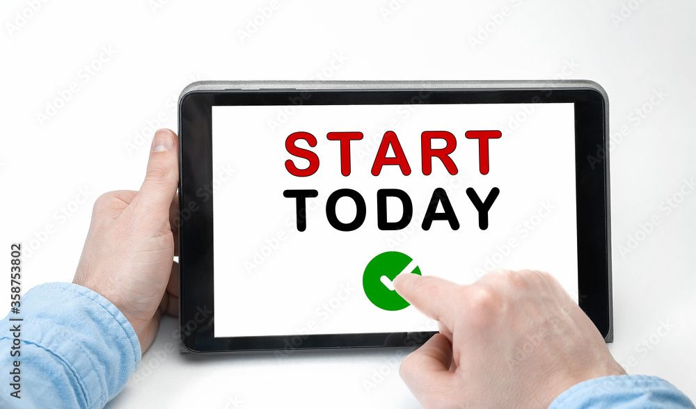 Male hands holding tablet pc with text START TODAY on white background Male hands holding tablet pc with text START TODAY on white background