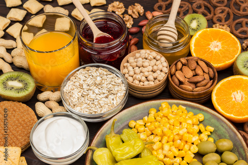 Set of products for breakfast: orange, juice, yogurt, jam, oatmeal. Top View.