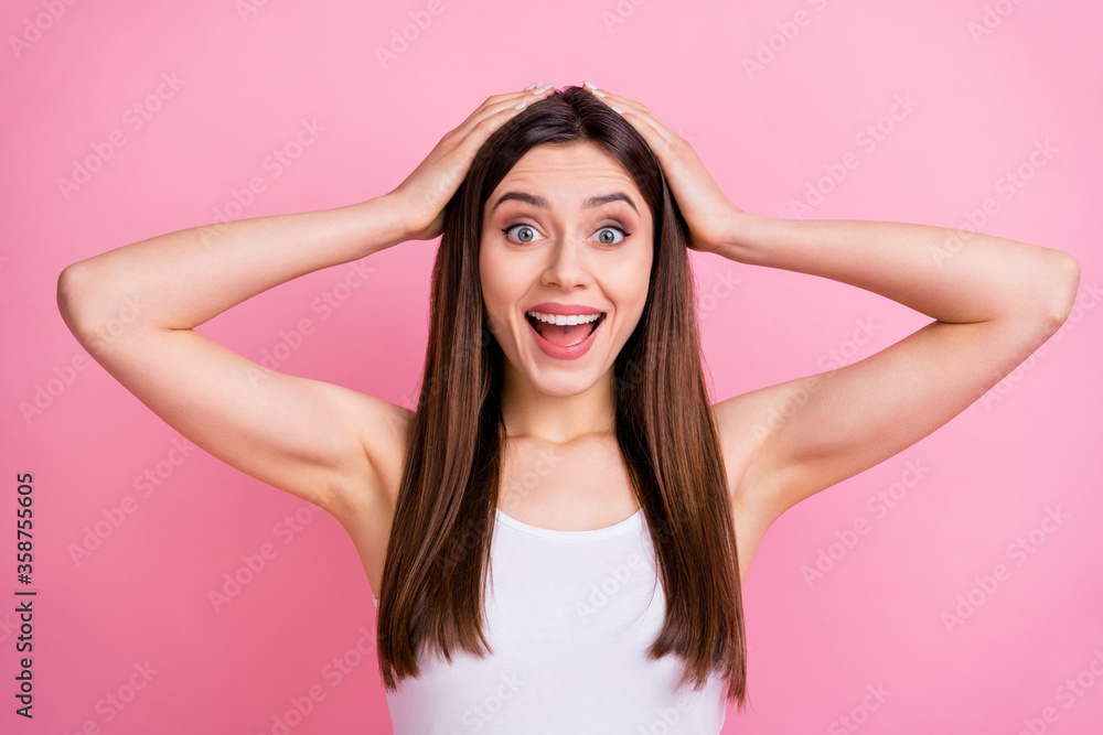 Closeup photo of pretty shocked lady long perfect hairstyle listen amazing news open mouth arms on head wear casual white singlet isolated pastel pink color background
