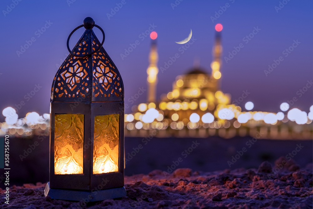 The spirit of Ramadan, a lantern decor in the heritage  area against crescent moon sky background

