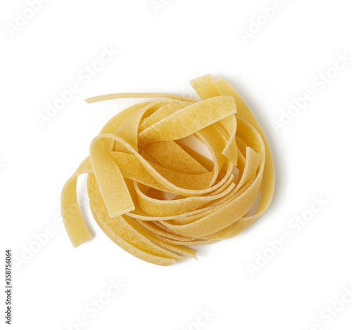 twisted pasta in a round fettuccine nest on a white isolated background
