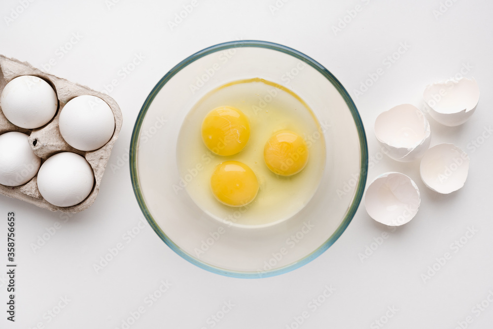 egg yolk in a bowl, a raw egg, eggs on a white background egg yolk in a bowl, a raw egg, eggs on a white background