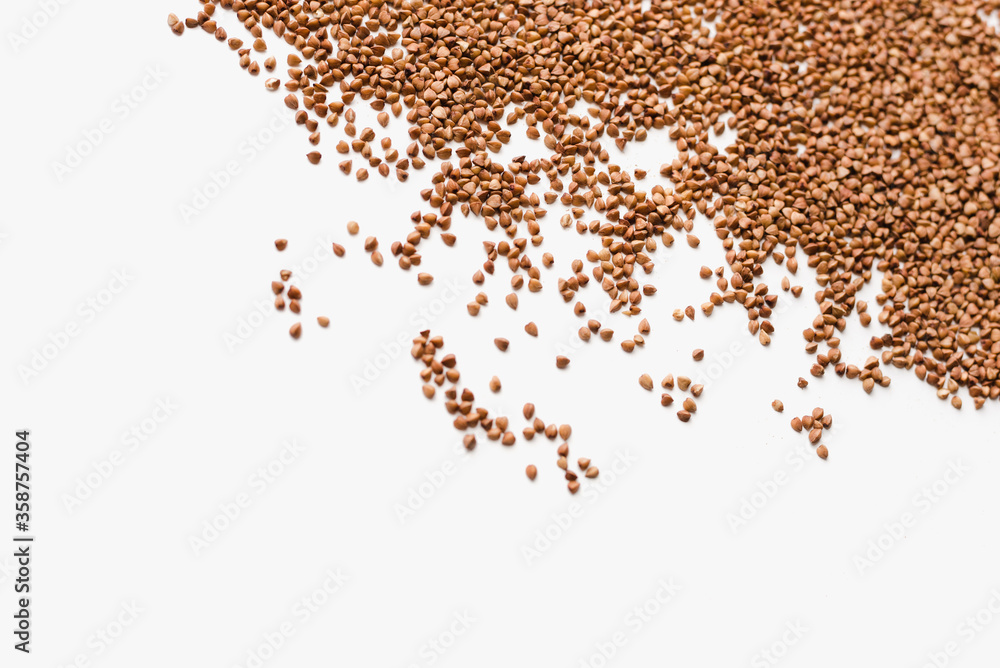 Fototapeta premium buckwheat groats on a white background, a bunch of buckwheat