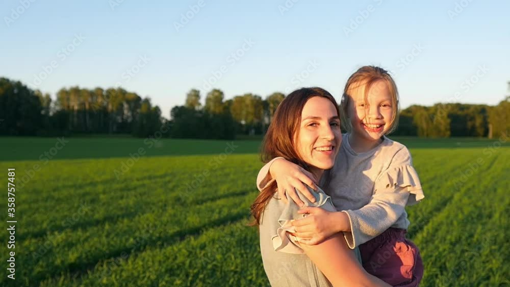 Baby boy and mother in summer sunlight in a park. Little girl hugs mom. Baby have fun. Slow motion. The concept of a happy family. A child works with his mother. Baby boy and mother in summer sunlight in a park. Little girl hugs mom. Baby have fun. Slow motion. The concept of a happy family. A child works with his mother.